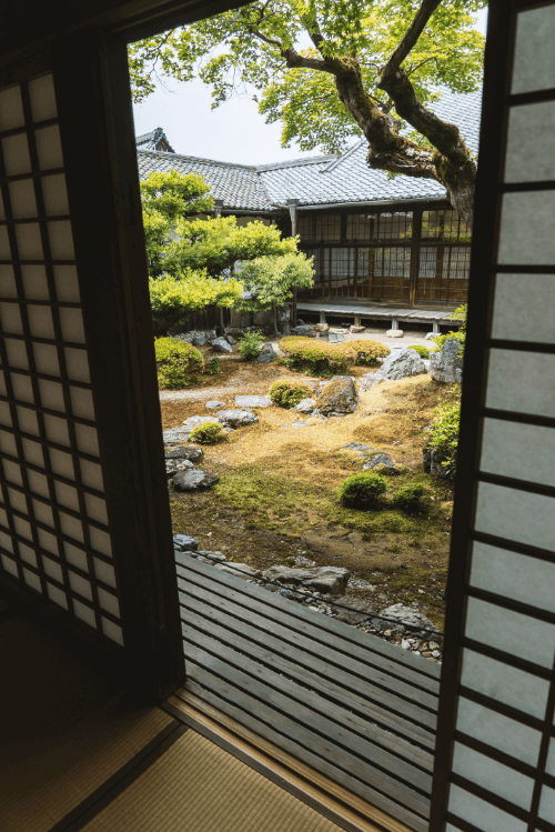 View through sliding door of serene courtyard.